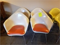four white molded plastic chairs