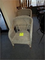 two natural wicker armchairs