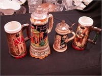 Four beer steins: two are lidded, one is a music