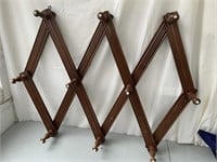 Expanding hat rack with white knobs
