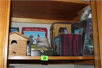 shelf of indian plates and figuires, bird house