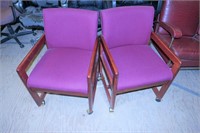 Two upholstered office chairs with casters