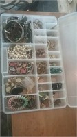 Plastic divided container of costume jewelry