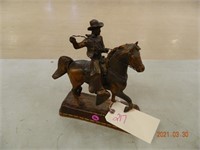 Copper colored metal cowboy statue