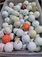 Used golf balls in a tub