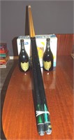 2 Pool Cues and 2  Dom Pewrion Bottles (empty)