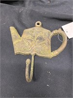 Five tea pot coat hooks. Cast-iron. 7 inches wide
