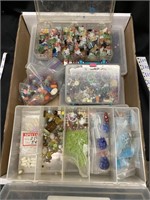 Six plastic containers full of beads of all kinds