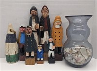 Group of wooden sailor sculptures and vase full