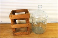 Vintage glass water jug in wood crate