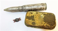 20mm bullet, military pin, and ww1 medical kit