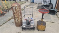 Snowblower propane tank and oil container.