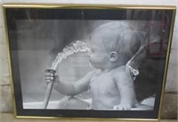 Baby playing with water hose print in frame