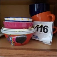 Shelf full of plastic bowls & ceramic coffee mugs