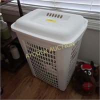 White clothes hamper with several pairs of