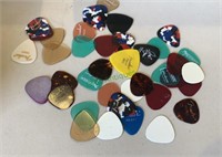 Collection of 35 guitar picks - most are Fenders