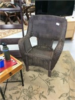 A pair of brown wicker chairs