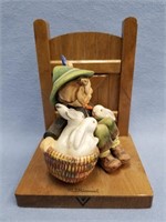 Hummel figurine of a boy with a basket of bunnies