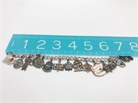 Charm bracelet with various charms, some sterling