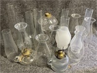 Several glass covers for oil lamps and 3 oil