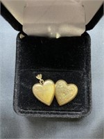 10 karat gold heart shaped locket engraved with a