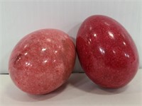 Two red alabaster eggs