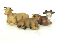 Pair of ceramic cattle figures and one resin cow