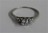 18kt white gold 3 stone engagement ring containing