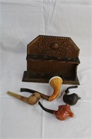 Carved wood pipe holder with four pipes,