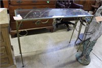 Cast metal entry table with glass top and grape