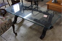 Glass top coffee table with dark stained claw