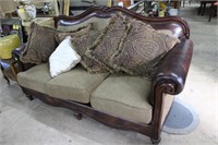 Brown leather trimmed 3 cushion sofa.

Dark