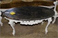 Oval marble topped coffee table on white painted