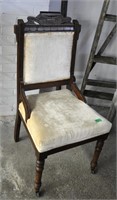 Antique Eastlake chair (front wheels)