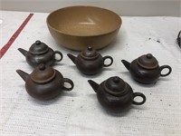 5 clay tea pots and plastic bowl