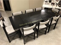 Black wood dining table with eight chairs