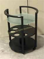 Small rolling stand with glass shelf