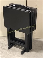 Set of four black TV trays with stand