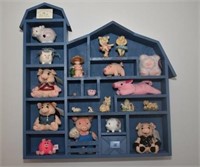 BLUE BARN SHELF WITH ASSORTED PIG FIGURINES