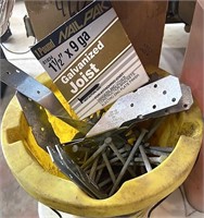 Yellow bucket with nails