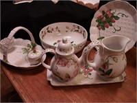 Eight decorated china serving pieces: five are