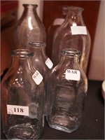 Six Fire-King baby bottles; three are 5" and