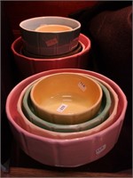 Nine art pottery nesting bowls, two sets