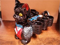 Black cat decanter with six small hanging mugs,