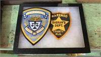 2 Alabama police badges in display