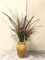 Tall pottery vase with arrangement