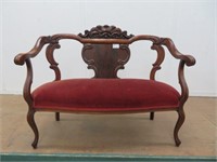 CARVED MAHOGANY SETTEE W/ RED UPHOLSTERED SEAT