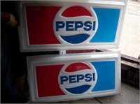 two plastic PEPSI signs