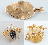 3 Yellow gold brooches.
