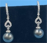 One pair of 14K white gold earrings with brilliant